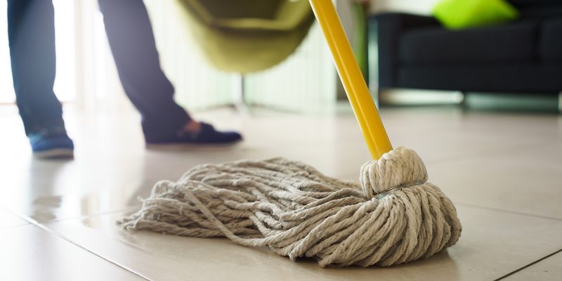 Woman Doing Chores Cleaning Floor At Home Focus on Mop Woman Doing Chores Cleaning Floor